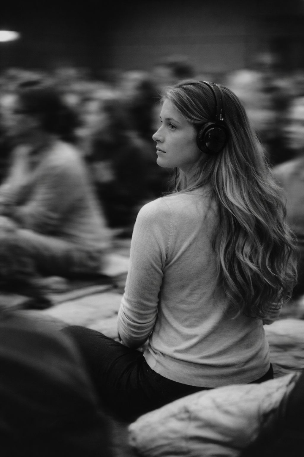 Audience member lost in thought in a crowded room