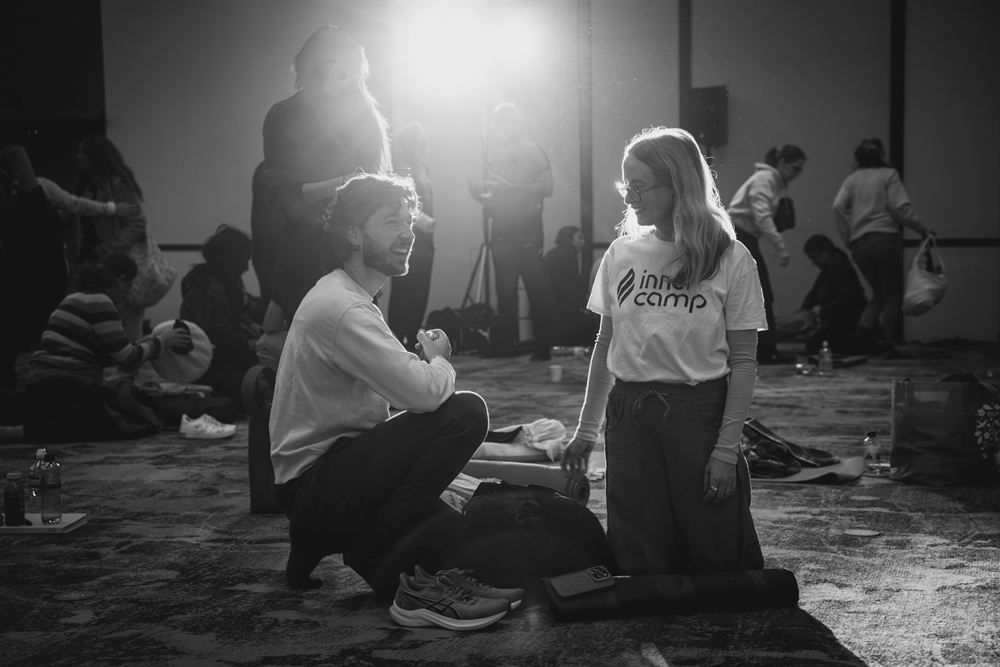 Two participants in candid conversation after an InnerCamp session